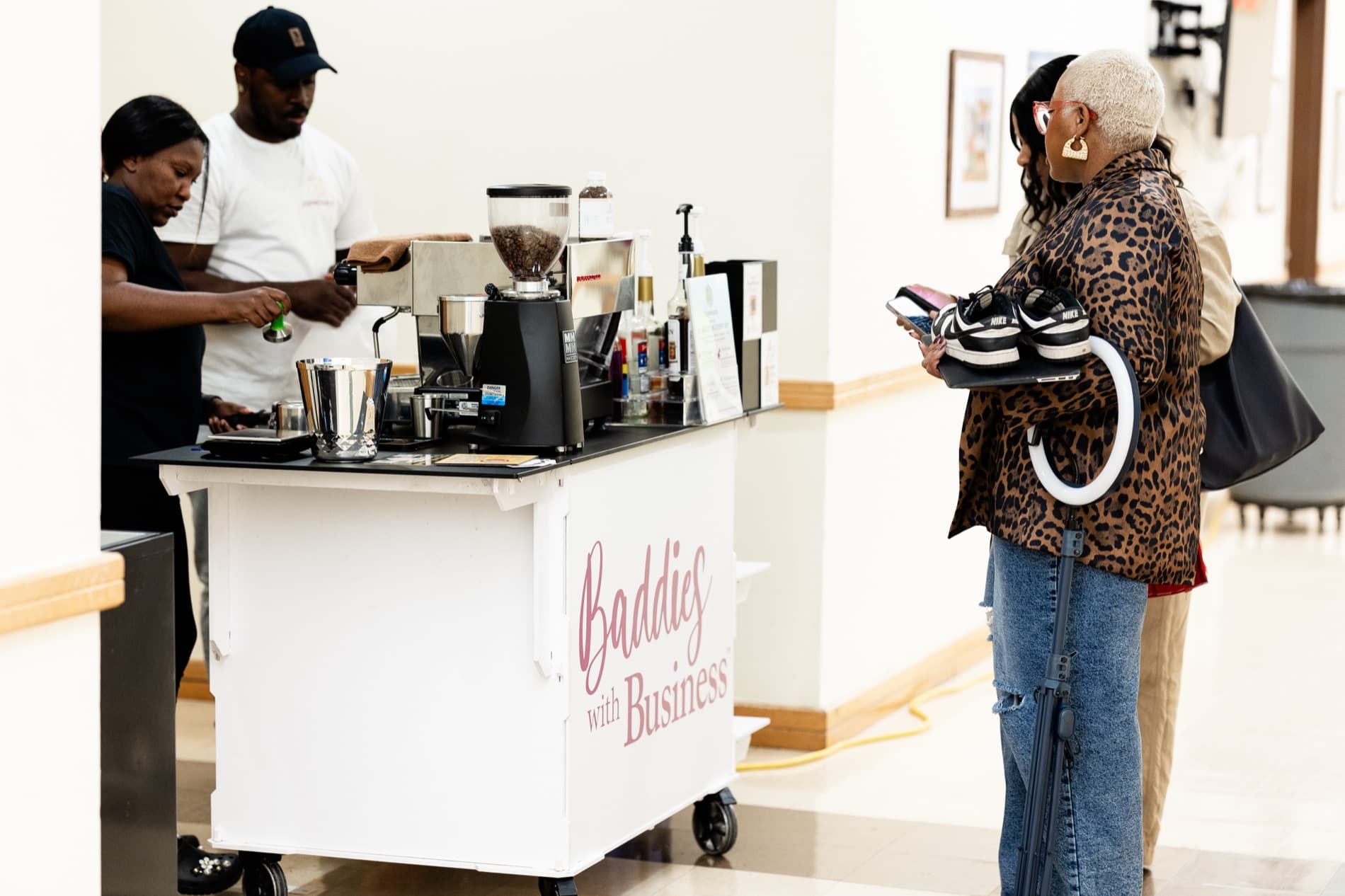 The Espréssate coffee cart wrapped in a client's own Baddies with Business branding, serving guests at a brand activation
